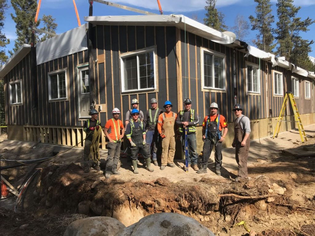 modular construction team in front of a build